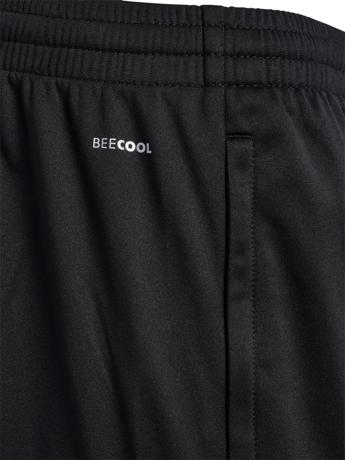Close-up of the waistband on black Hummel referee training pants