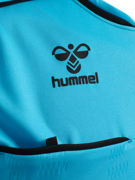 Close-up of the Hummel logo and chest pocket on the blue Hummel 2026 referee shirt
