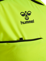 Close-up of the Hummel logo and chest pocket on the yellow Hummel 2026 referee shirt