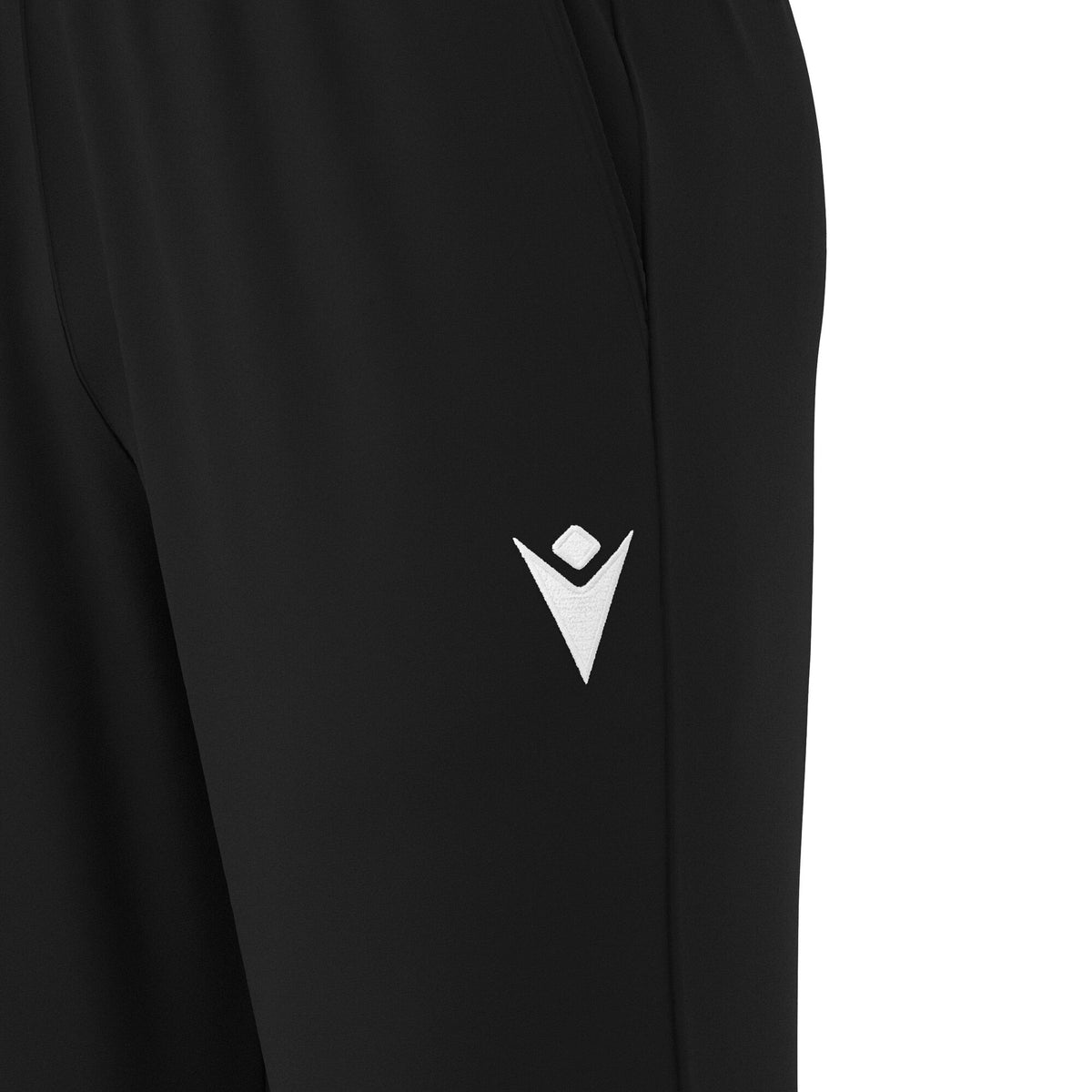 Close-up of the Macron logo on the leg of black Macron referee training pants
