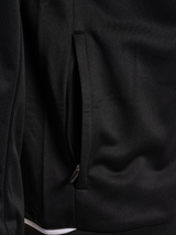 Close-up of the zipped side pocket on the black Hummel referee full-zip jacket