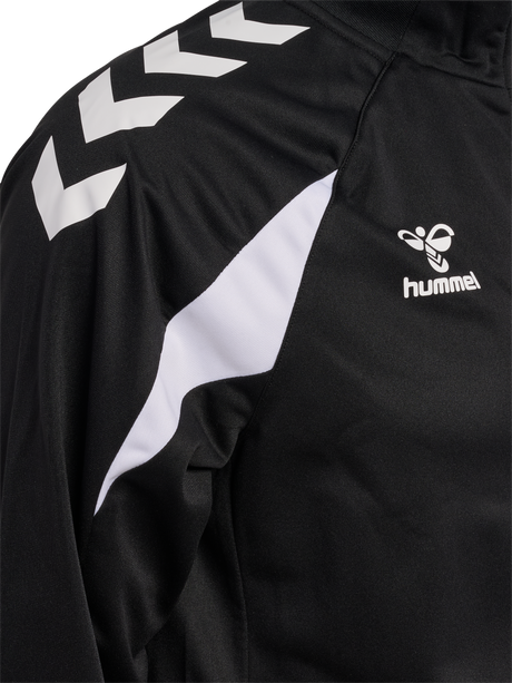 Close-up of the Hummel logo and chevron sleeve on the black Hummel referee full-zip jacket