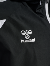 Close-up of the Hummel logo on the black Hummel referee rain jacket