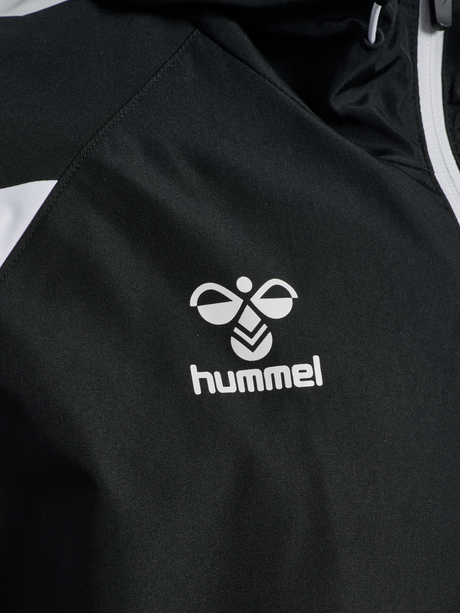 Close-up of the Hummel logo on the black Hummel referee rain jacket