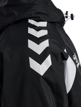 Close-up of the white chevrons on the sleeve of the black Hummel referee rain jacket