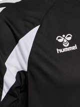 Close-up of the Hummel logo and sleeve detail on the black Hummel referee training top