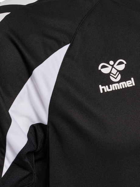 Close-up of the Hummel logo and sleeve detail on the black Hummel referee training top