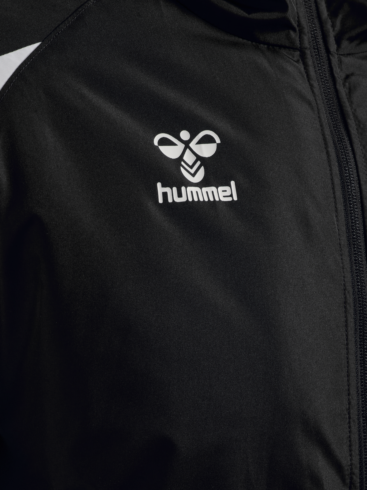 Close-up of the Hummel logo on the black Hummel referee winter coat