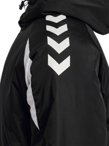 Close-up of the white chevrons on the sleeve of the black Hummel referee winter coat