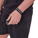 Referee wearing the A&H black wrist lanyard with a whistle attached