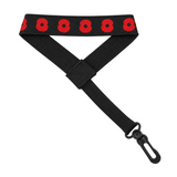 A black webbed strap with a repeating red poppy pattern along the top edge and a black metal swivel clasp at the end.