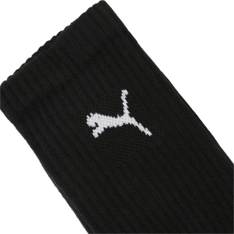 Close-up of the white Puma logo on the black Puma crew socks