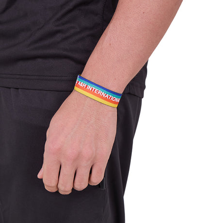 Referee wearing the A&H rainbow wrist lanyard on the wrist