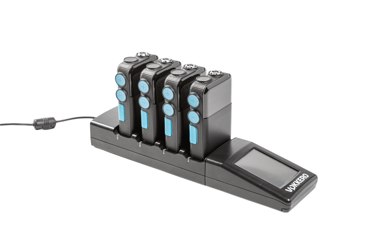 A black Vokkero multi-device charging dock with four charging slots holding black devices with blue circular accents, shown on a white background with a power cable extending from the left.