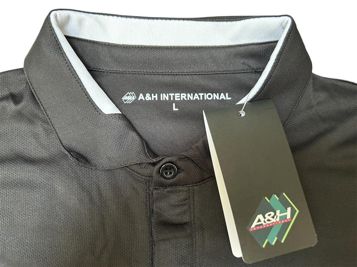 Close-up of the collar and A&H swing tag on the black A&H referee shirt