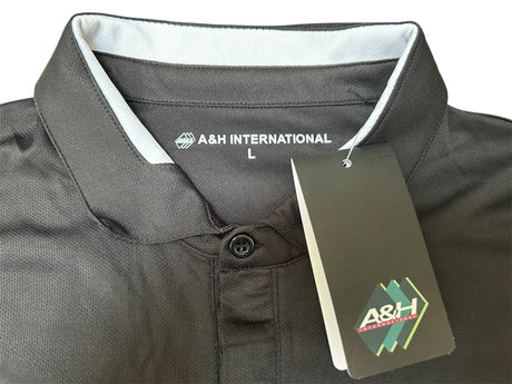 Close-up of the collar and A&H swing tag on the black A&H referee shirt