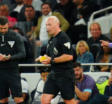 Referee in a stadium using a yellow match wallet during a match