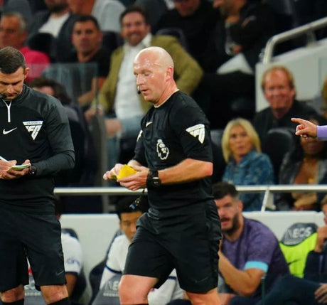Referee in a stadium using a yellow match wallet during a match