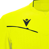 Close-up of the Macron logo and chest pocket stripe on the yellow Macron Ponnet referee shirt