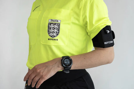Referee wearing the Spintso Refcom II armband unit and earpiece